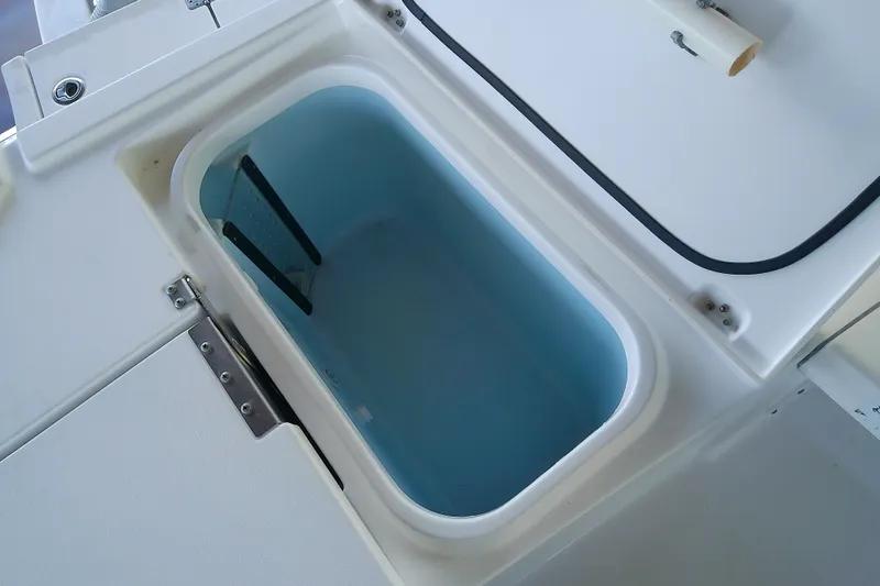 Slide: The Image of Livewell compartment on a 2015 Crevalle 24 Bay boat, open and empty. - 17