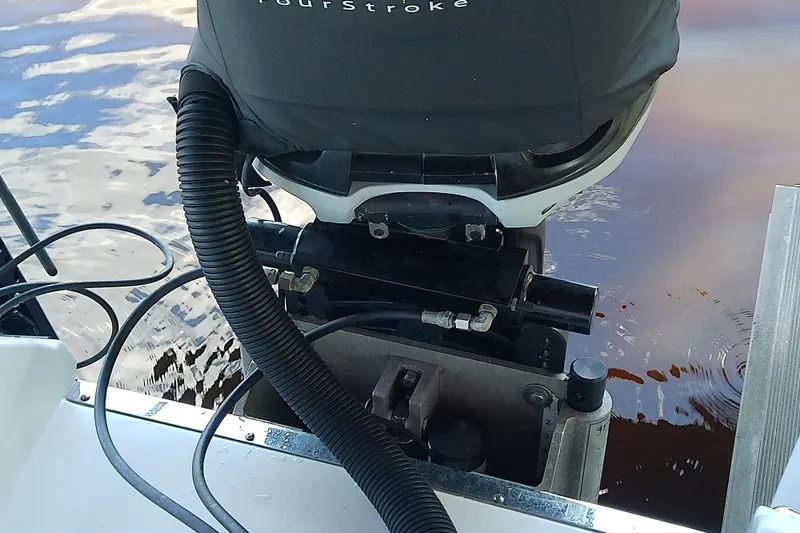 Slide: The Image of Outboard motor on 2015 Crevalle 24 Bay boat, close-up view. - 13