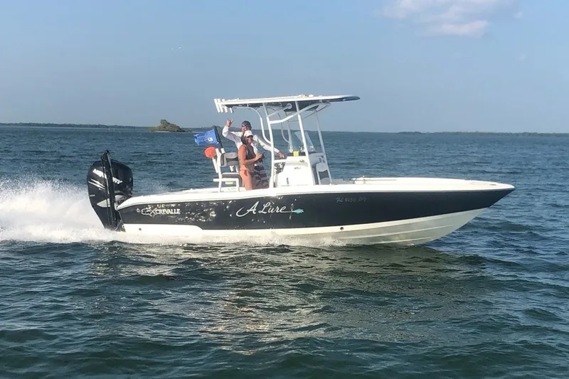 Slide: The Image of 2015 Crevalle 24 Bay boat cruising on open water with passengers onboard. - 47
