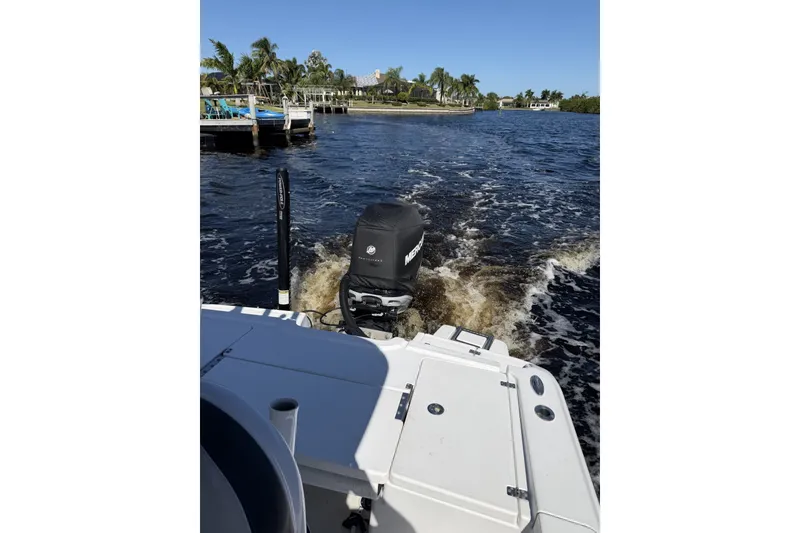 Slide: The Image of 2015 Crevalle 24 Bay boat cruising on a sunny day near a dock. - 41