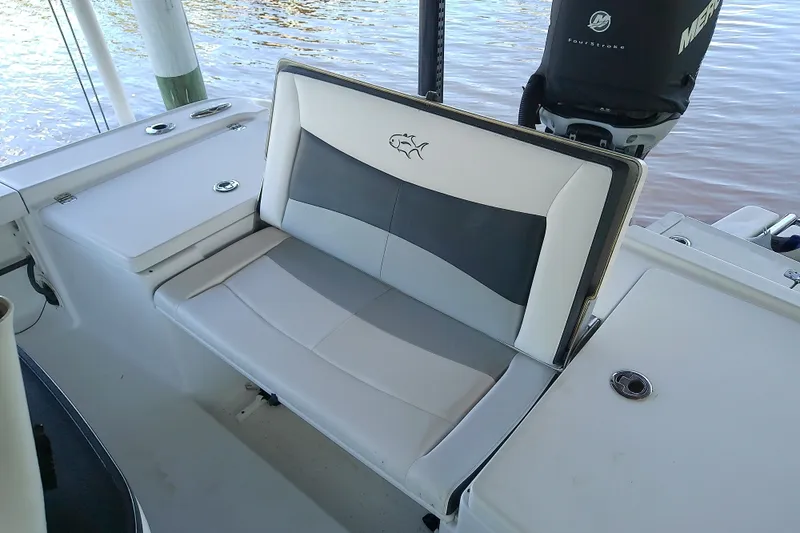 Slide: The Image of 2015 Crevalle 24 Bay boat interior with cushioned seating and Mercury outboard motor. - 14