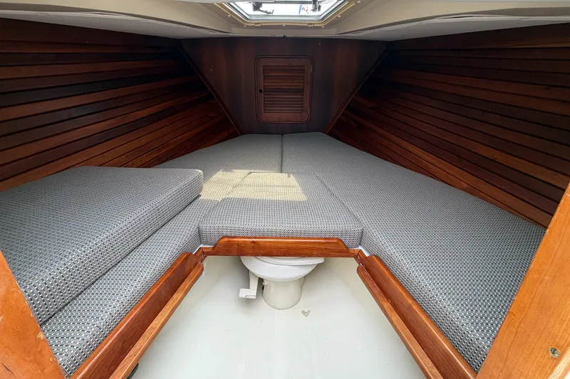 Slide: The Image of 2007 Hinckley Talaria 29R cabin interior with wooden paneling and cushioned seating. - 20
