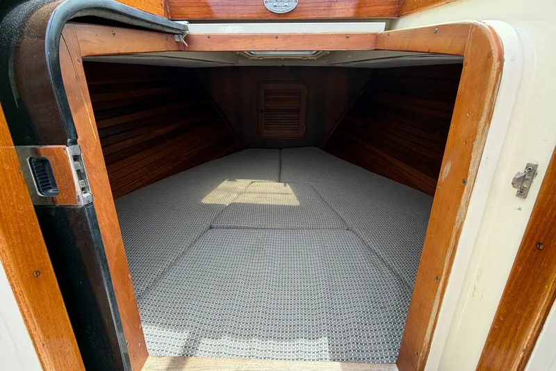 Slide: The Image of 2007 Hinckley Talaria 29R cabin interior with wooden finish and carpeted flooring. - 19