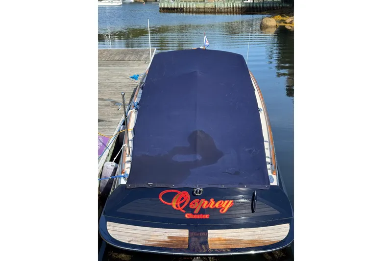 Slide: The Image of 2007 Hinckley Talaria 29R boat docked, covered with a navy blue tarp. - 21