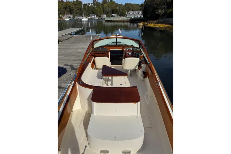 Slide: The Image of 2007 Hinckley Talaria 29R boat interior with wooden accents, docked in a serene marina. - 15