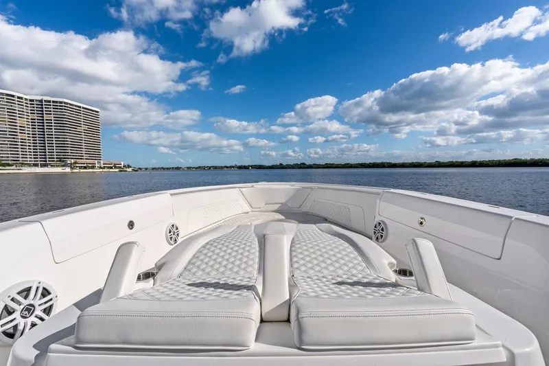 Slide: The Image of 2022 Intrepid 407 Nomad FE boat with luxurious seating, on a serene waterway. - 12