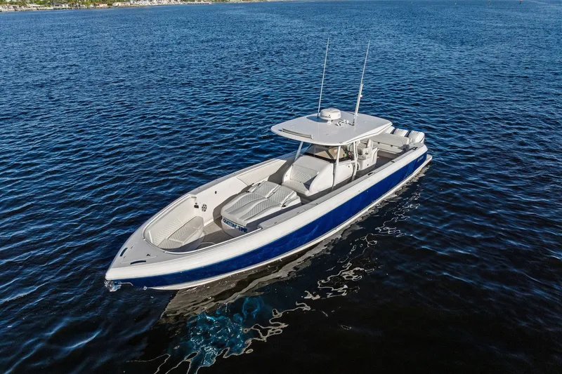 Slide: The Image of 2022 Intrepid 407 Nomad FE boat on calm blue water, aerial view. - 5