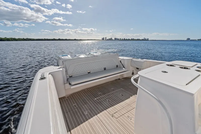 Slide: The Image of 2022 Intrepid 407 Nomad FE boat on calm water with city skyline in background. - 25