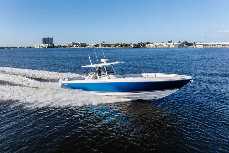 Slide: The Image of 2022 Intrepid 407 Nomad FE cruising on open water, showcasing sleek design and performance. - 0