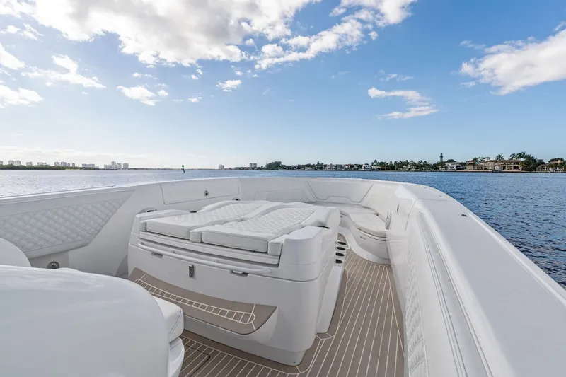Slide: The Image of 2022 Intrepid 407 Nomad FE boat interior with luxurious seating on a sunny day. - 14