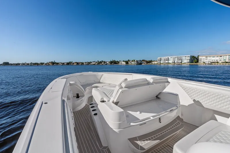 Slide: The Image of 2022 Intrepid 407 Nomad FE boat with luxurious seating on calm waters. - 11