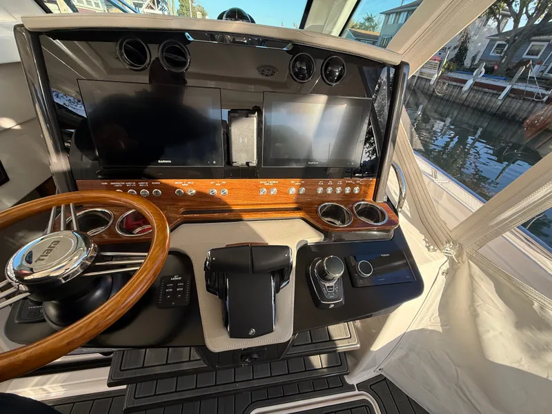 Slide: The Image of The cockpit of a 2025 Tiara Yachts 34 LS with wood paneling and modern instruments. - 24