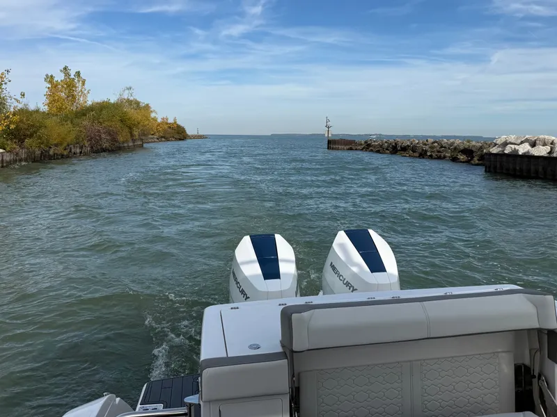 Slide: The Image of The image shows the stern of a 2025 Tiara Yachts 34 LS on a river or canal. - 11