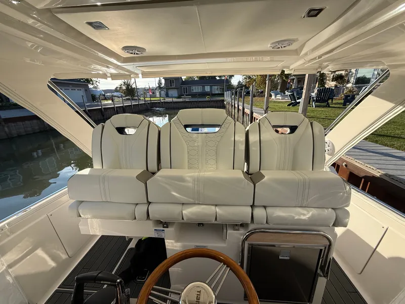 Slide: The Image of The image shows the cockpit of a 2025 Tiara Yachts 34 LS with elegant white seating. - 26