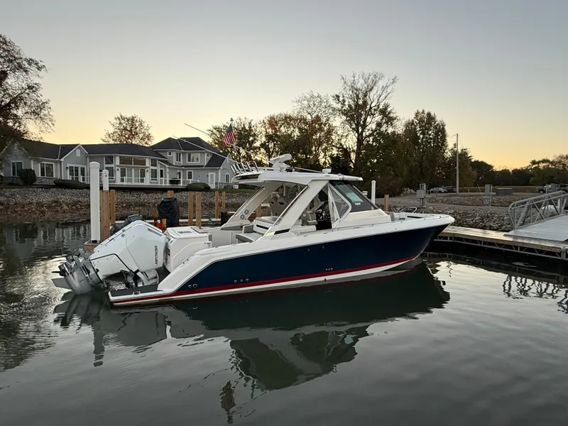 Slide: The Image of A 2025 Tiara Yachts 34 LS docked in calm waters at sunset. - 3