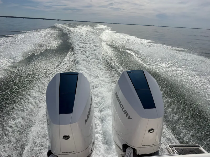 Slide: The Image of Two Mercury outboard engines propel a boat across calm water, leaving a frothy wake. - 13