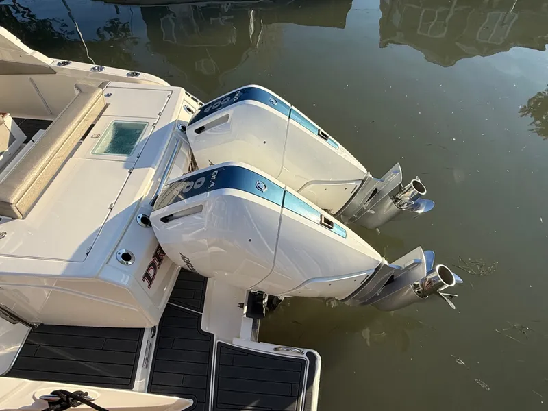 Slide: The Image of Two powerful outboard engines on a 2025 Tiara Yachts 34 LS in the water. - 8
