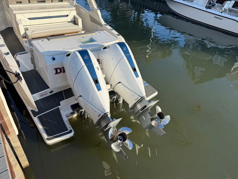 Slide: The Image of Two powerful outboard engines on a 2025 Tiara Yachts 34 LS, docked in the water. - 10