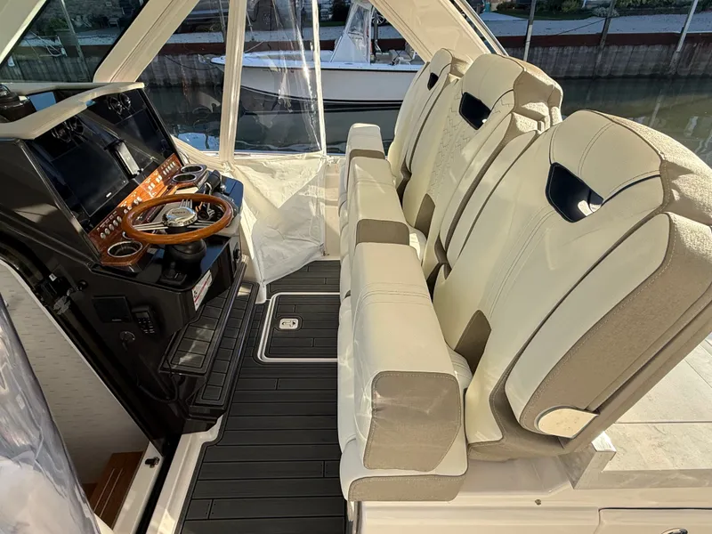 Slide: The Image of Interior of the 2025 Tiara Yachts 34 LS with luxurious seating and a modern helm. - 21