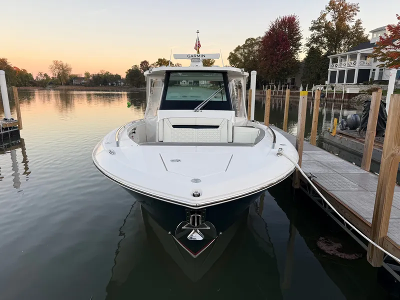 Slide: The Image of 2025 Tiara Yachts 34 LS docked, surrounded by calm water and autumn trees. - 14