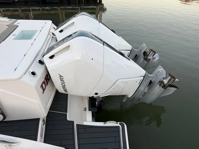 Slide: The Image of Two Mercury outboard engines on a 2025 Tiara Yachts 34 LS, resting in the water. - 9