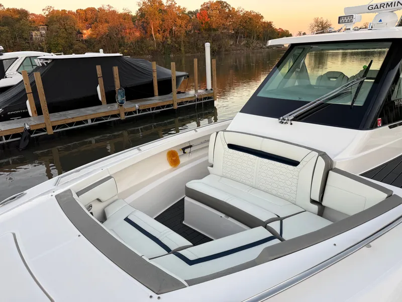 Slide: The Image of The image shows the bow of a 2025 Tiara Yachts 34 LS with sleek white seating. - 16