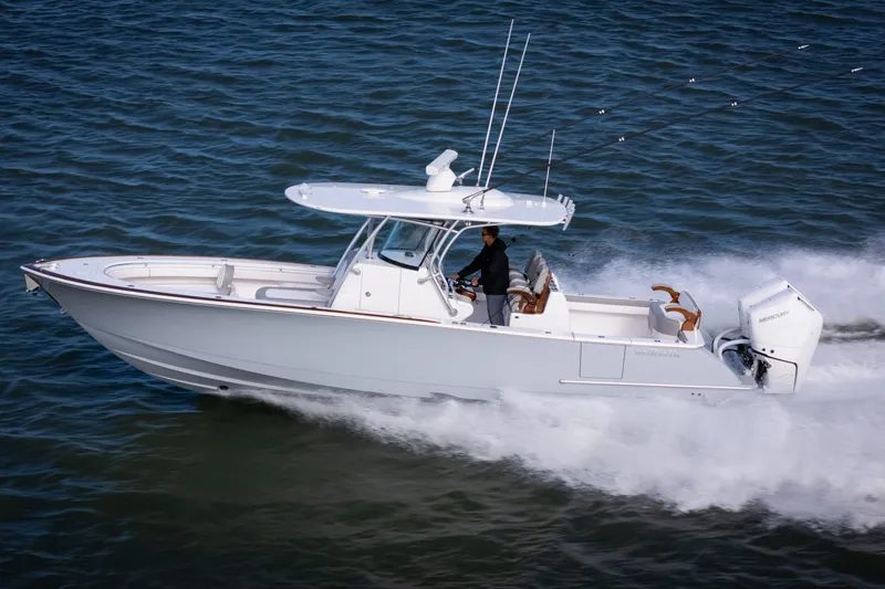 Slide: The Image of 2025 Valhalla V-33 boat cruising swiftly on open water. - 9
