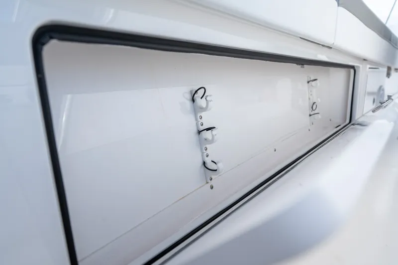 Slide: The Image of Storage compartment on 2025 Valhalla V-33 boat, featuring hooks and sleek design. - 37