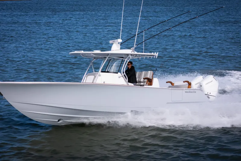 Slide: The Image of 2025 Valhalla V-33 boat cruising on open water with fishing rods. - 8
