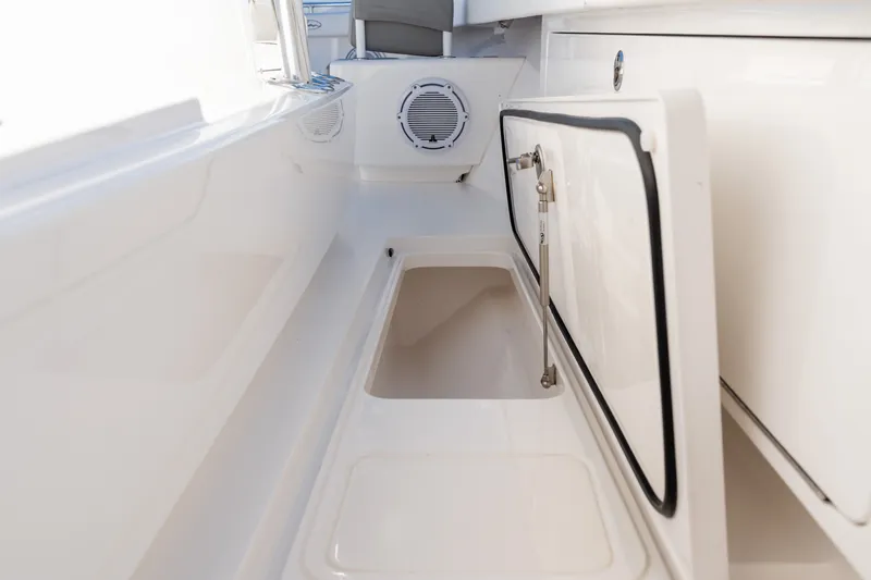 Slide: The Image of Interior storage compartment of 2025 Valhalla V-33 boat, featuring sleek white design. - 19
