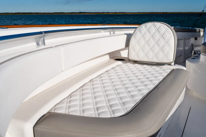 Slide: The Image of Luxurious seating on 2025 Valhalla V-33 boat with quilted upholstery, ocean backdrop. - 13