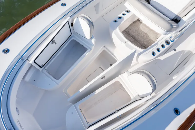Slide: The Image of 2025 Valhalla V-33 boat interior with storage compartments and seating. - 16