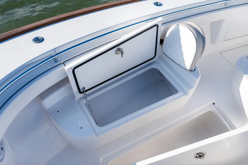 Slide: The Image of Open storage compartment on 2025 Valhalla V-33 boat deck. - 17