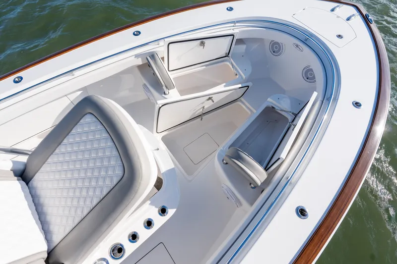 Slide: The Image of Luxurious 2025 Valhalla V-33 boat interior with cushioned seating and storage compartments. - 18