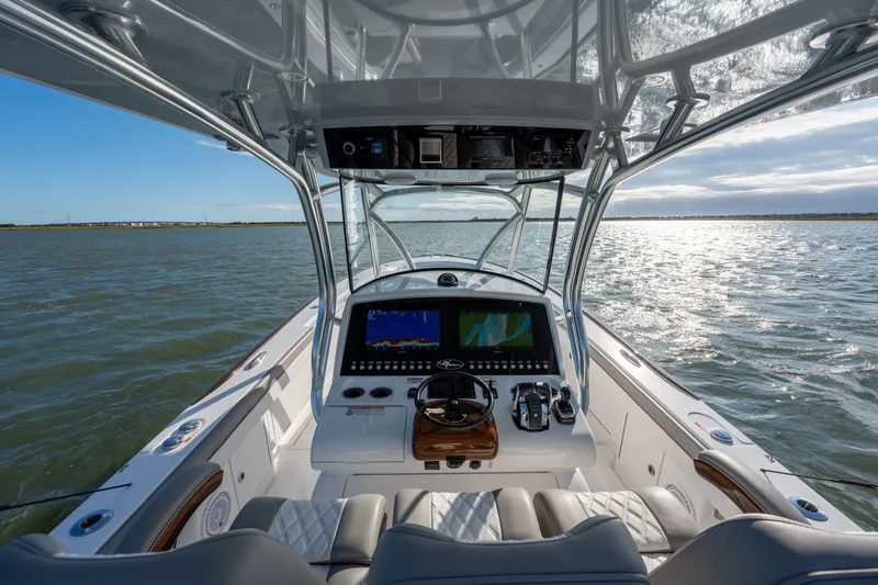 Slide: The Image of Cockpit view of 2025 Valhalla V-33 boat on open water, featuring advanced navigation systems. - 23