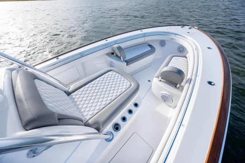 Slide: The Image of Luxurious 2025 Valhalla V-33 boat interior with quilted seating on calm water. - 15