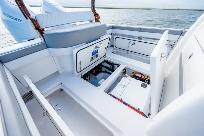 Slide: The Image of 2025 Valhalla V-33 boat interior with open storage compartments and visible engine components. - 36