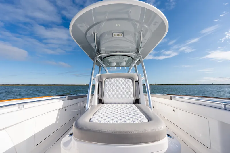 Slide: The Image of 2025 Valhalla V-33 boat interior with luxurious seating, ocean view, and clear sky. - 14