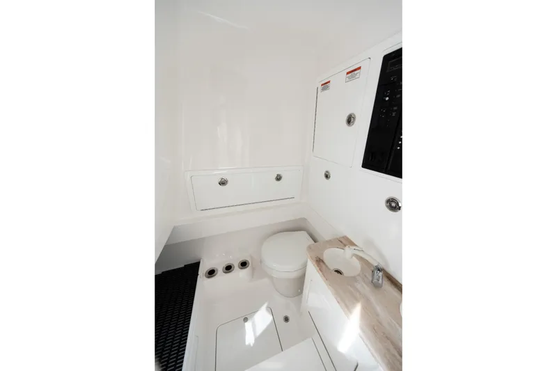 Slide: The Image of 2025 Valhalla V-33 boat interior bathroom with modern fixtures and white cabinetry. - 38