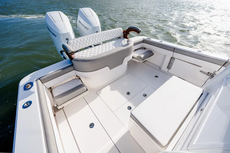 Slide: The Image of 2025 Valhalla V-33 boat deck with dual Mercury engines on water. - 30