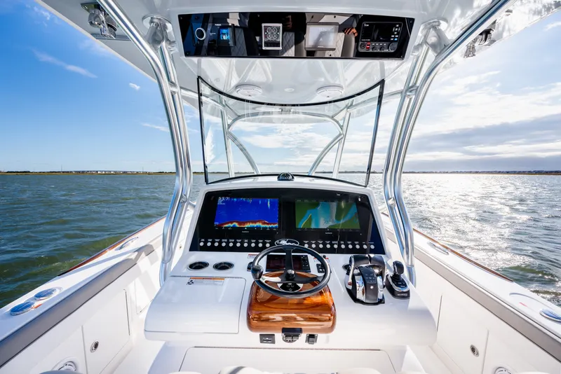 Slide: The Image of Cockpit view of 2025 Valhalla V-33 boat with advanced navigation systems on open water. - 22