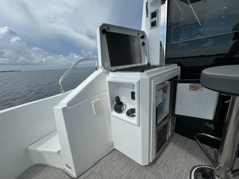 Slide: The Image of 2021 Cruisers Yachts 60 Cantius Flybridge outdoor kitchenette with ocean view. - 42