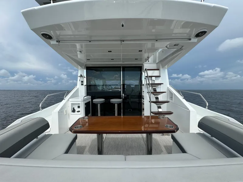 Slide: The Image of 2021 Cruisers Yachts 60 Cantius Flybridge, elegant deck with seating and ocean view. - 40