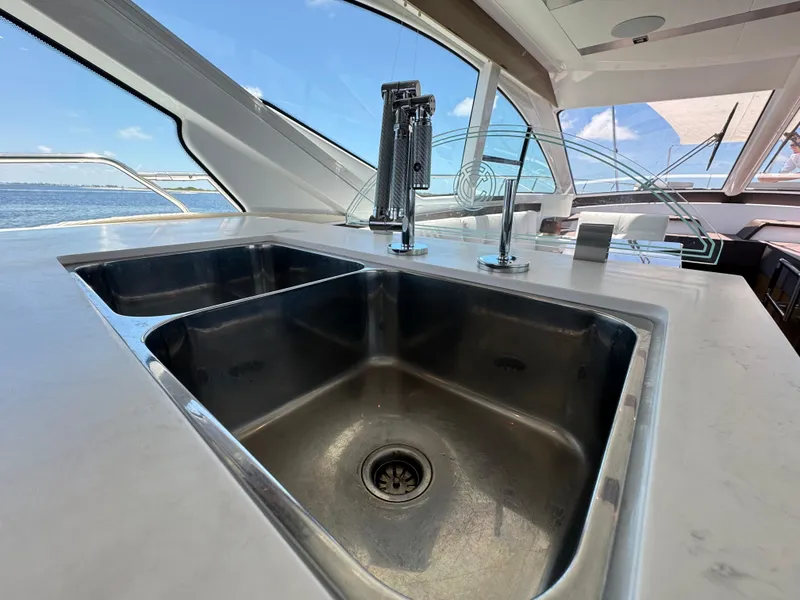 Slide: The Image of Luxurious kitchen sink on 2021 Cruisers Yachts 60 Cantius Flybridge with ocean view. - 19