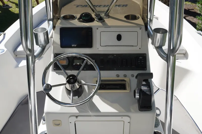 Slide: The Image of Center console of a 2000 Pathfinder 2200 V boat with steering wheel and controls. - 12