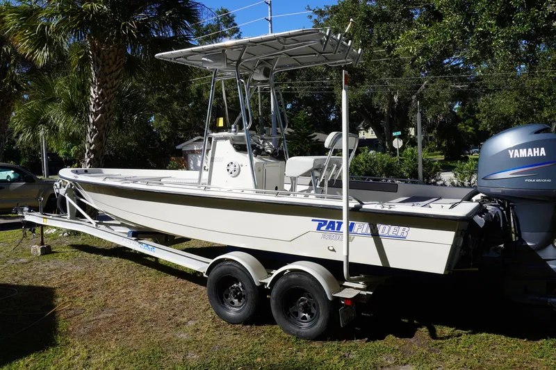 Slide: The Image of 2000 Pathfinder 2200 V boat on trailer with Yamaha outboard motor, parked outdoors. - 1