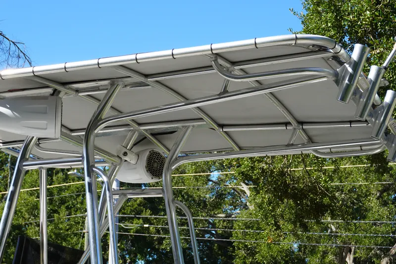 Slide: The Image of T-top of a 2000 Pathfinder 2200 V boat with rod holders and speakers. - 11