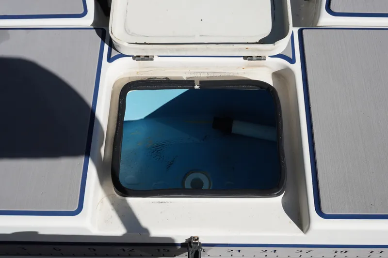 Slide: The Image of Open hatch on 2000 Pathfinder 2200 V boat deck, revealing interior compartment. - 10