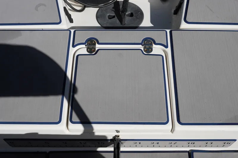 Slide: The Image of Deck of 2000 Pathfinder 2200 V boat with storage hatch and measuring ruler. - 9