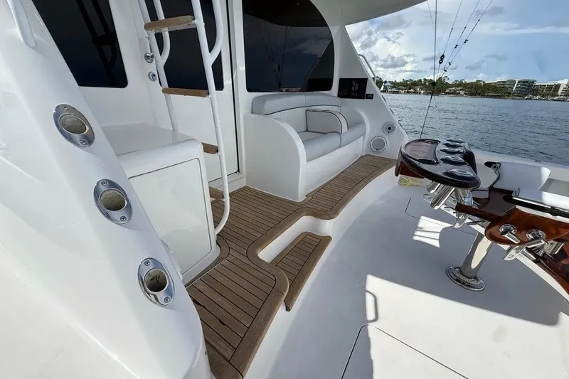 Slide: The Image of 2018 Viking 52 Convertible yacht deck with seating and fishing rod holders. - 33